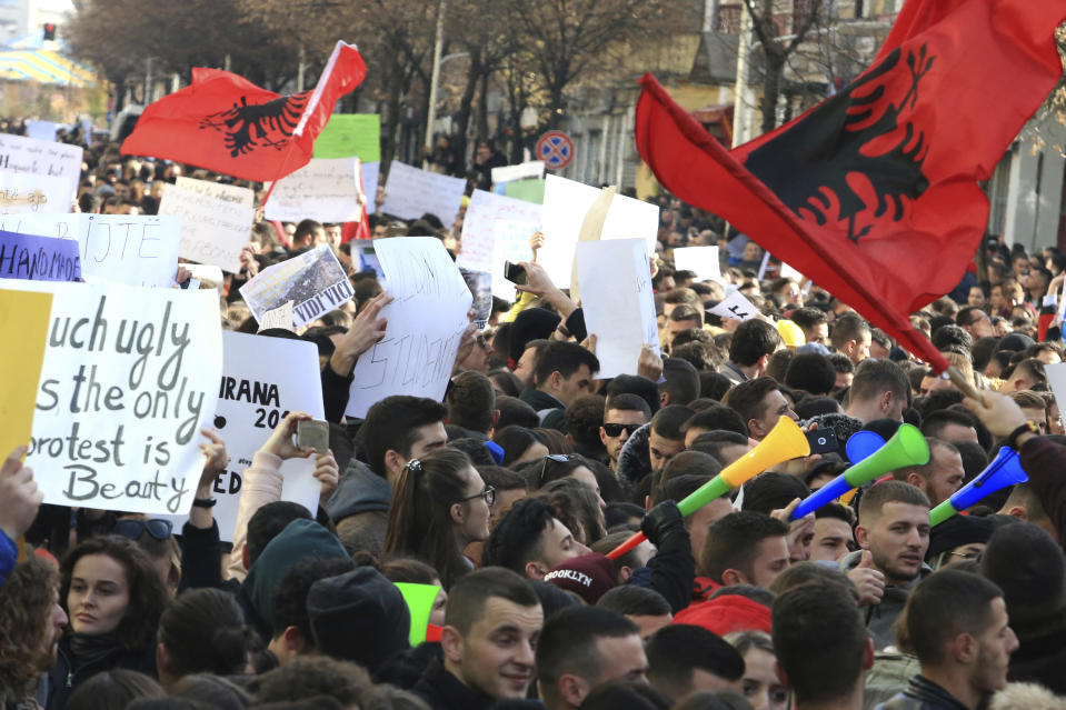 Albania University students protest outside the Education Ministry in Tirana, Tuesday, Dec. 11, 2018. Student demands include cutting tuition fees in half, doubling the budget for education and a greater student presence on decision-making boards. (AP Photo/ Hektor Pustina)