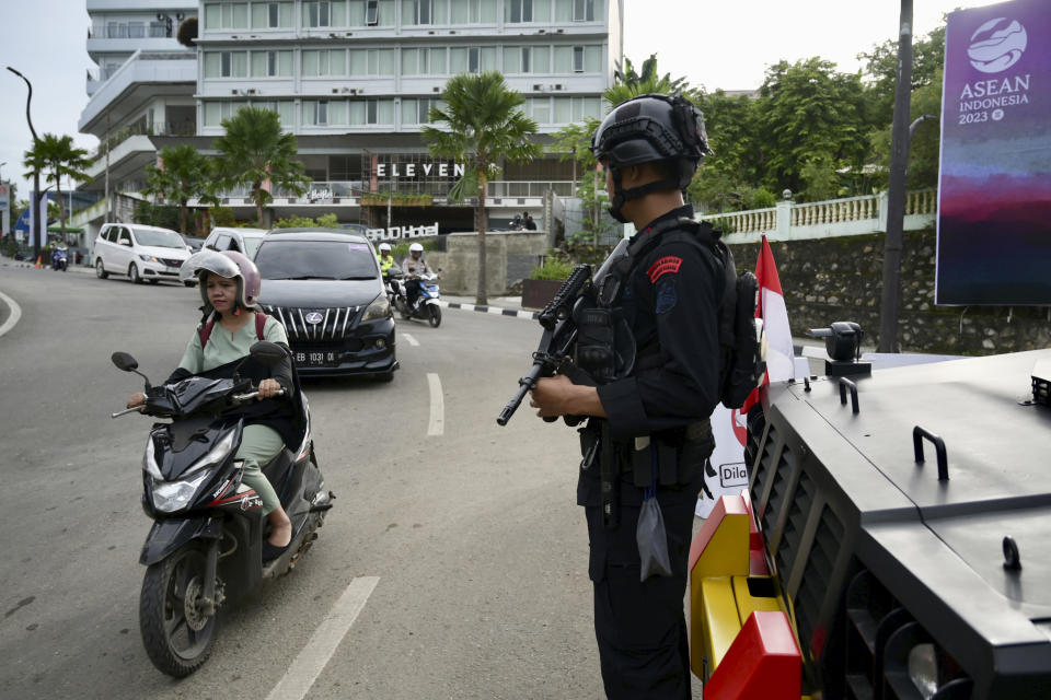 A police officer stands guard on roadside during the 42nd Southeast the Association of Southeast Asian Nations meetings in Labuan Bajo, Indonesia, Tuesday, May 9, 2023. (Bay Ismoyo/Pool Photo via AP)