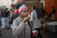 A farmer drinks tea as he participates in protest against new farm laws at the Delhi-Uttar Pradesh state border, India, Wednesday, Jan. 20, 2021. Farmers have been blockading highways connecting New Delhi to northern India for nearly seven weeks against new farm laws, obstructing transportation and dealing a blow to manufacturing and businesses in the north. Farmers fear the government will stop buying grain at minimum guaranteed prices and that corporations will then push prices down under the new laws. (AP Photo/Altaf Qadri)