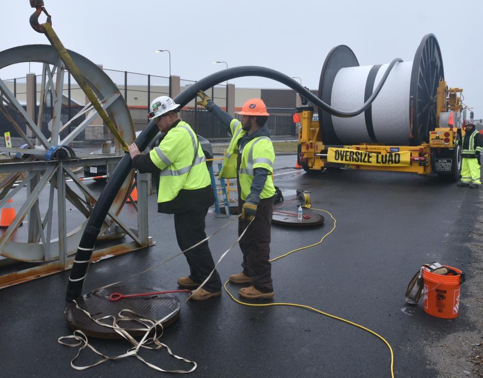 HYANNIS 01/05/23 Workers with Elecnor Hawkeye finish up the end of a 3000 foot spool of electric cable where it was sent into underground conduit along Attuck's Lane in Hyannis. The cable will bring the electricity from the offshore Vineyard Wind project to a substation located off Independence Drive.  Steve Heaslip/Cape Cod Times 