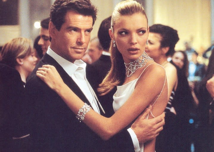 A man holds a blonde woman in The Thomas Crown Affair.