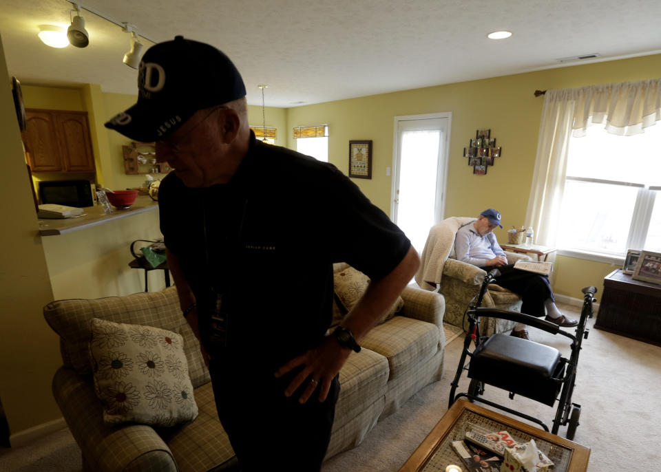 In this Nov. 21, 2013, photo, Paul Gregoline rests in his favorite chair as caregiver Warren Manchess leaves the room, in Noblesville Ind. Burgeoning demand for senior services like home health aides is being met by a surprising segment of the workforce: Other seniors. Twenty-nine percent of so-called direct-care workers are projected to be 55 or older by 2018 and in some segments of that population older workers are the single largest age demographic. With high rates of turnover, home care agencies have shown a willingness to hire older people new to the field who have found a tough job market as they try to supplement their retirement income.(AP Photo/Darron Cummings)