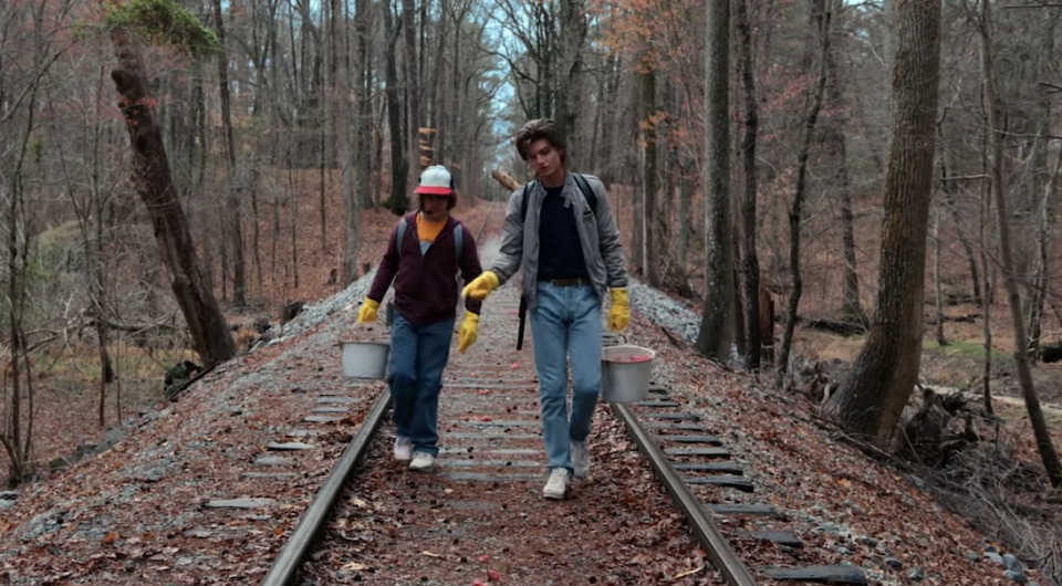 Steve and Dustin walking on the tracks