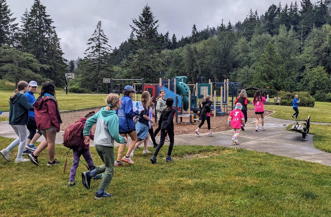 Girls on the Run and Trail Blazers members run with the peace torch at Lake Padden in Bellingham on June 27, 2024.