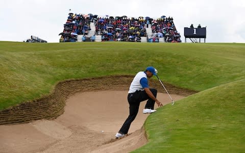 Woods climbing out of a bunker - Credit: R&amp;A