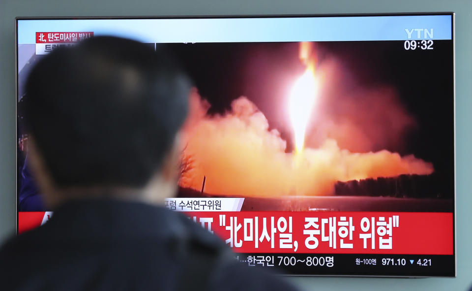 <em>A man watches a TV screen showing a local news program reporting with a file footage of North Korea’s missile launch in South Korea (AP)</em>