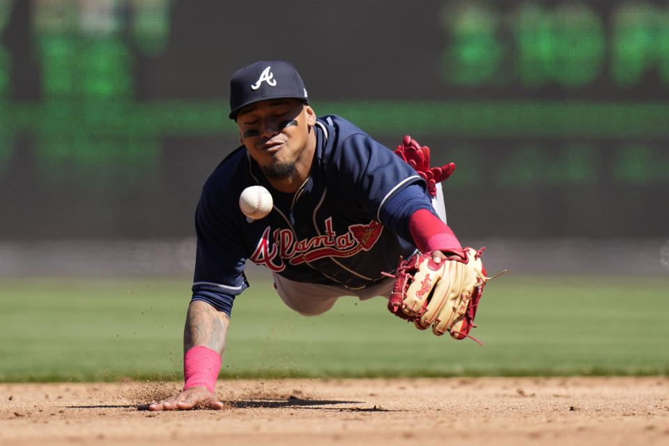 Atlanta Braves shortstop Orlando Arcia loses a pop-up single in the sun that was hit by Washington Nationals' Dominic Smith during the second inning of an opening day baseball game at Nationals Park, Thursday, March 30, 2023, in Washington. (AP Photo/Alex Brandon)