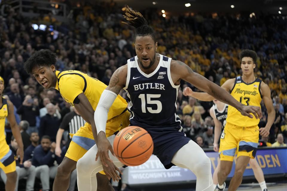 Marquette's Olivier-Maxence Prosper and Butler's Manny Bates battle for the ball during the second half of an NCAA college basketball game Saturday, Feb. 4, 2023, in Milwaukee. Marquette won 60-52. (AP Photo/Morry Gash)