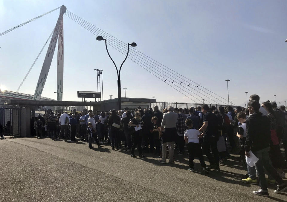 In this Sunday, March 24 2019 photo, spectators queue to enter the Allianz Arena to watch the Italian league women’s match between Juventus Women and Fiorentina Women, in Turin, Italy. The exceptional growth of women’s soccer took another leap forward when 39,000 people packed into the Allianz Stadium to watch Juventus Women beat Fiorentina Women 1-0 on a sunny Sunday afternoon. That was a record attendance in Italy that far eclipsed the old mark of 14,000. (AP Photo/Daniella Matar)