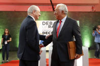 In this Sept. 23, 2019 file picture, Portuguese Prime Minister and Socialist Party leader Antonio Costa shakes hands with Social Democratic Party leader Rui Rio, left, before an election debate on national radio in Lisbon. The two mainstream parties are expected to garner most votes in upcoming Sunday's General Election ballot, with the center-left Socialist Party showing an opinion poll lead of at least 7 percentage points over the center-right Social Democratic Party. (AP Photo/Armando Franca)