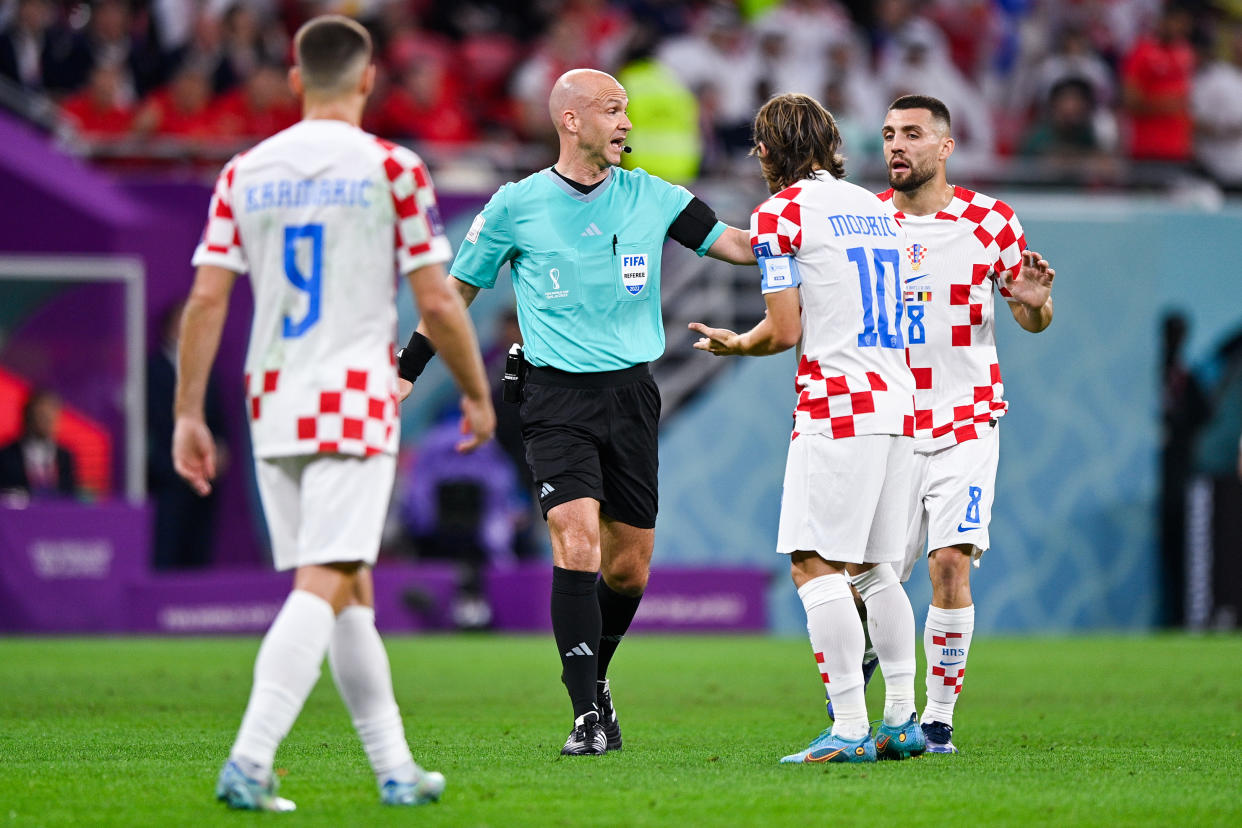 DOHA, QATAR - DECEMBER 1: Referee Anthony Taylor, Luka Modric of Croatia and Mateo Kovacic of Croatia in action during the Group F - FIFA World Cup Qatar 2022 match between Croatia and Belgium at the Ahmad Bin Ali Stadium on December 1, 2022 in Doha, Qatar (Photo by Pablo Morano/BSR Agency/Getty Images)