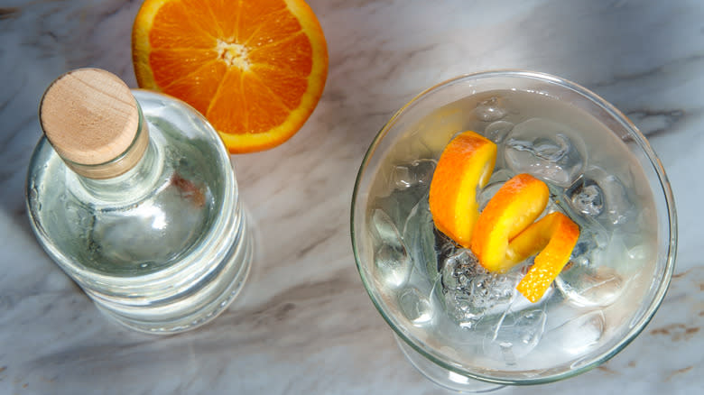 Rocks martini with orange and gin bottle