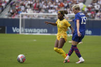 United States forward Megan Rapinoe, right, kicks past South Africa forward Noxolo Cesane during the first half of a soccer game against, Sunday, Sept. 24, 2023, in Chicago. (AP Photo/Erin Hooley)