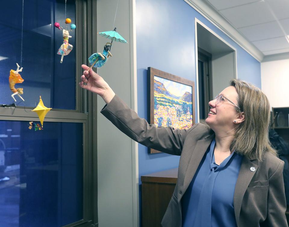 Chief of Strategy Nanette Pitt shows off some of the artwork in her new office at Akron City Hall.