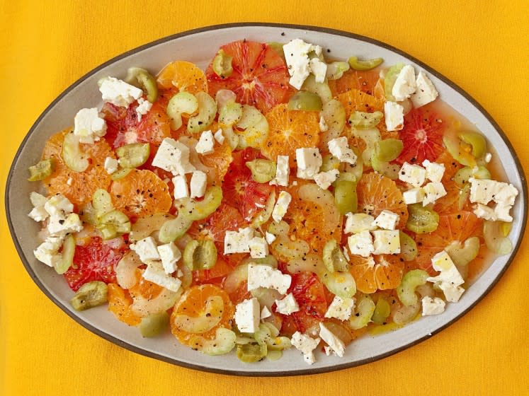 Seasonal Cook-- cold and salty orange salad. This is a salad of sweet orange citrus marinated in a salty-things vinaigrette made with feta, grated celery, anchovies, salt-cured olives, and capers.