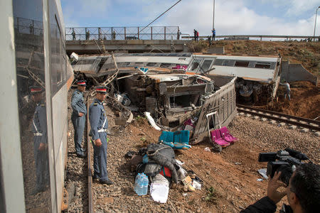 Security personnel stand at the site of a train derailment at Sidi Bouknadel near the Moroccan capital Rabat, Morocco, October 16, 2018. REUTERS/Youssef Boudlal