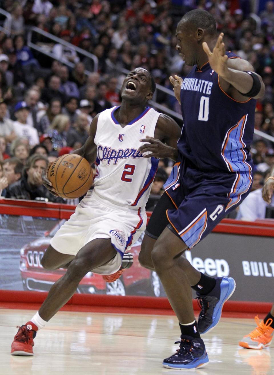 Los Angeles Clippers guard Darren Collison (2) collides with Charlotte Bobcats center Bismack Biyombo (0) during the first half of an NBA basketball game Wednesday, Jan. 1, 2014, in Los Angeles. (AP Photo/Alex Gallardo)