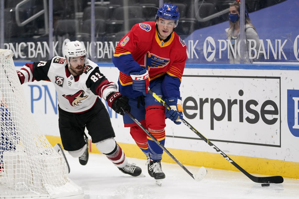 St. Louis Blues' Sammy Blais (9) controls the puck as Arizona Coyotes' Conor Garland (83) defends during the second period of an NHL hockey game Thursday, Feb. 4, 2021, in St. Louis. (AP Photo/Jeff Roberson)