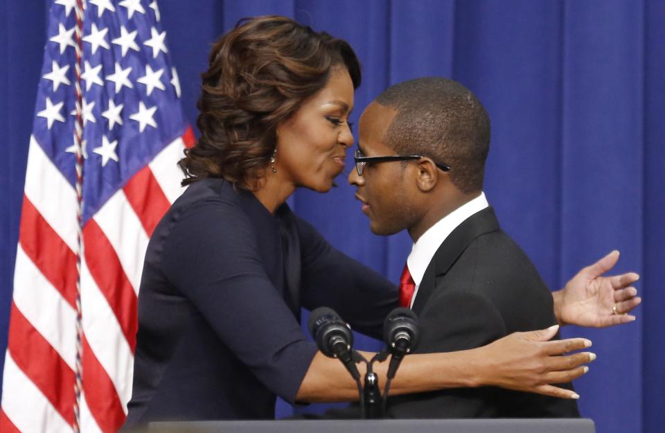 U.S. first lady Obama hugs college student Troy Simon during an event about college education at the White House in Washington