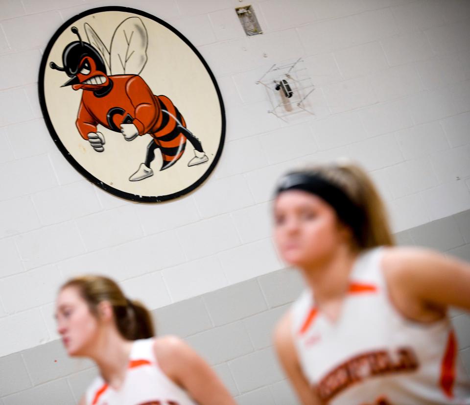 The logo for the Greenfield Yellowjackets can be seen on the wall of an older gym above players in an afternoon practice at Greenfield School in Greenfield, Tenn., on Thursday, Jan. 24, 2019.
