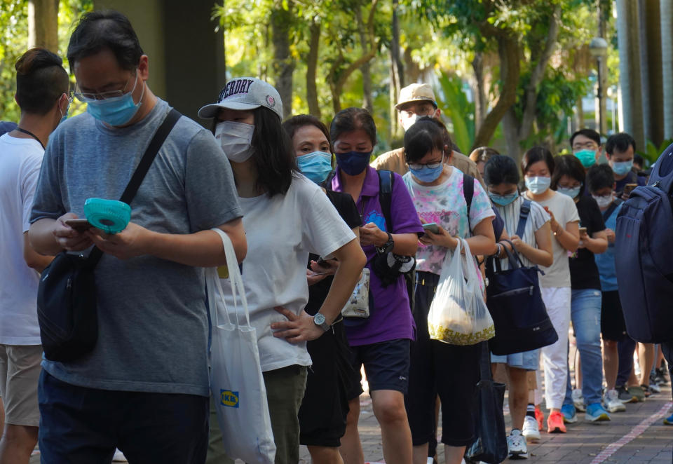 People queue up to vote in Hong Kong, Sunday, July 12, 2020, in an unofficial primary for pro-democracy candidates ahead of legislative elections in September. Over 200,000 Hong Kongers voted in an unofficial Hong Kong primary that will help the pro-democracy camp decide which candidates to field in legislative elections in September. The turnout exceeded organizers' estimates that some 170,000 people would turn up to vote over the weekend. (AP Photo/Vincent Yu)