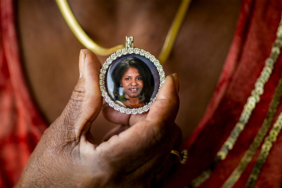 Ann Hill holds a picture of her youngest daughter Rhonda that she wears around her neck on Tuesday, April 6, 2021 in Cincinnati. Ann and Al Hill raised two daughters and 100 foster girls. Rhonda died in August 2020.