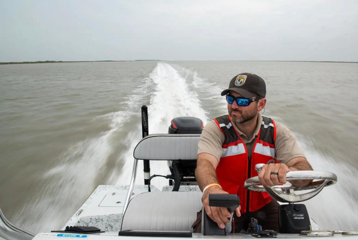 Andy Stetter navigates the Intracoastal Waterway near Port Aransas on April 1, 2024. The U.S. Fish and Wildlife wildlife biologist manages and monitors habitats at the Aransas National Wildlife Refuge.