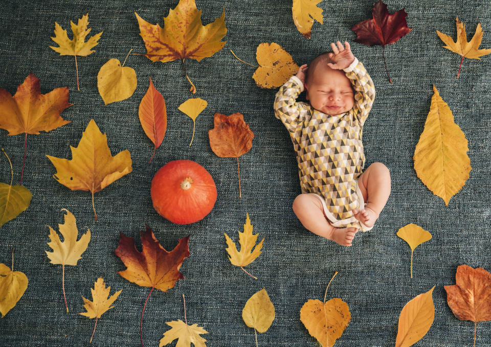 baby with autumn leaves