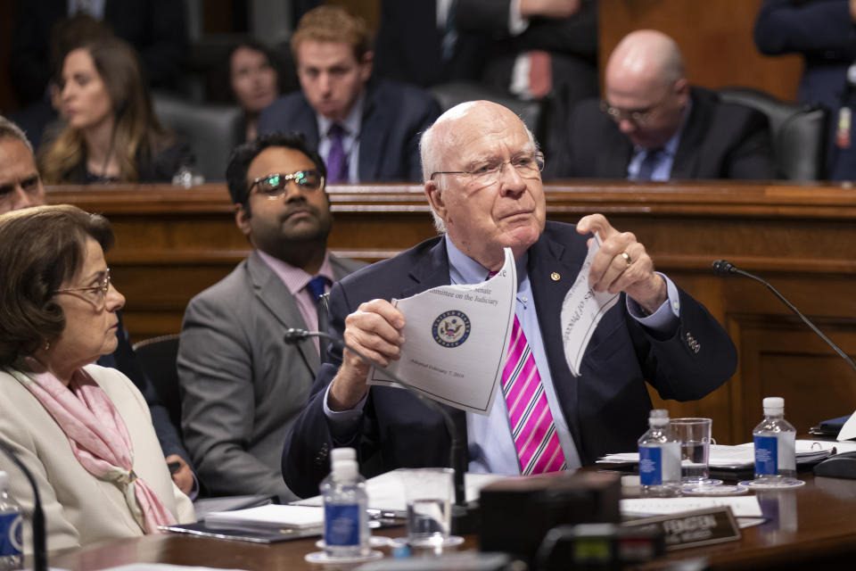 Sen. Patrick Leahy, D-Vt., a former chairman of the Senate Judiciary Committee, joined at left by Sen. Dianne Feinstein, D-Calif., rips a copy of the committee rules of procedure as he charges current Republican chairman Lindsey Graham with breaking the rules to bend to President Donald Trump on immigration policy, on Capitol Hill in Washington, Thursday, Aug. 1, 2019. (AP Photo/J. Scott Applewhite)