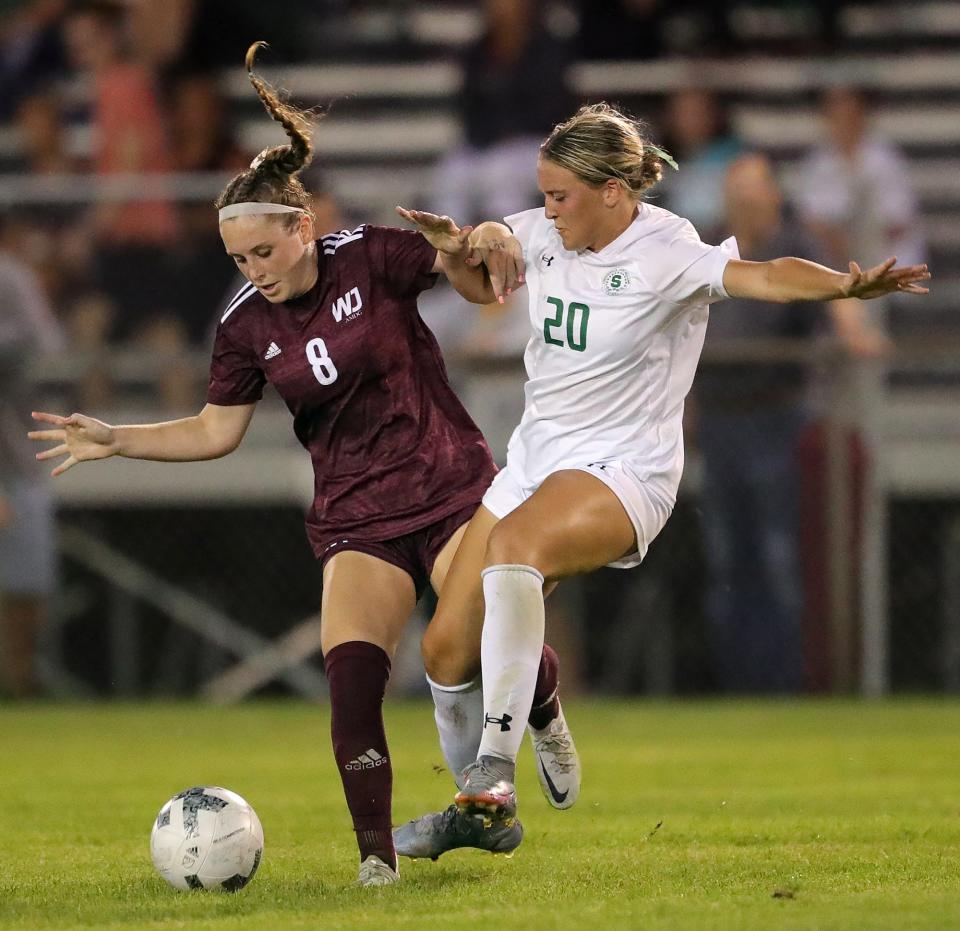 Walsh Jesuit's Reagan Pentz, left, and Strongsville's Grace Paczo battle for the ball during the second half of a soccer game, Wednesday, Aug. 24, 2022, in Cuyahoga Falls, Ohio.