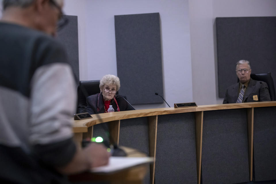 Cochise County Supervisor Ann English, second from left, and Tom Crosby, right, listen to public comments over a proposed transfer of election functions and duties to the county recorder at the Cochise County Board of Supervisors meeting, Tuesday, Feb. 14, 2023, in Bisbee, Ariz. (AP Photo/Alberto Mariani)