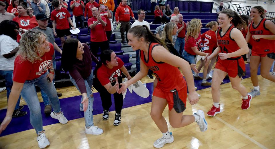 The Bedford girls basketball parents and fans greet Payton Pudlowski, Brooklyn Manard, Victoria Gray and the rest of the players after a 44-32 victory over Detroit Cass Tech in the finals of the Division 1 Regional at Woodhaven on Wednesday, March 13, 2024.