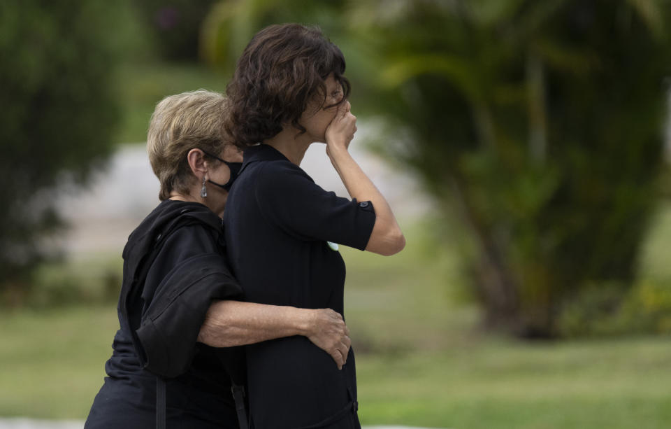 Alessandra Sampaio, right, cries as she arrives for the funeral of her husband British journalist Dom Phillips at the Parque da Colina cemetery, Niteroi, Brazil, Sunday, June 26, 2022. Family and friends paid their final respects to Phillips who was killed in the Amazon region along with the Indigenous expert Bruno Pereira. (AP Photo/Silvia Izquierdo)