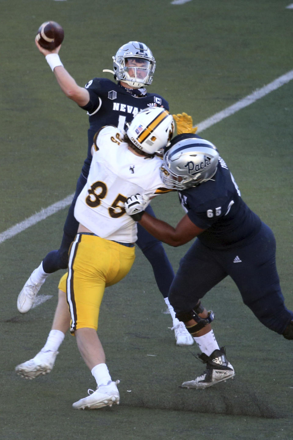 Nevada quarterback Carson Strong (12) throws a pass against Wyoming State during the first half of an NCAA college football game Saturday, Oct. 24, 2020, in Reno, Nev. (AP Photo/Lance Iversen)