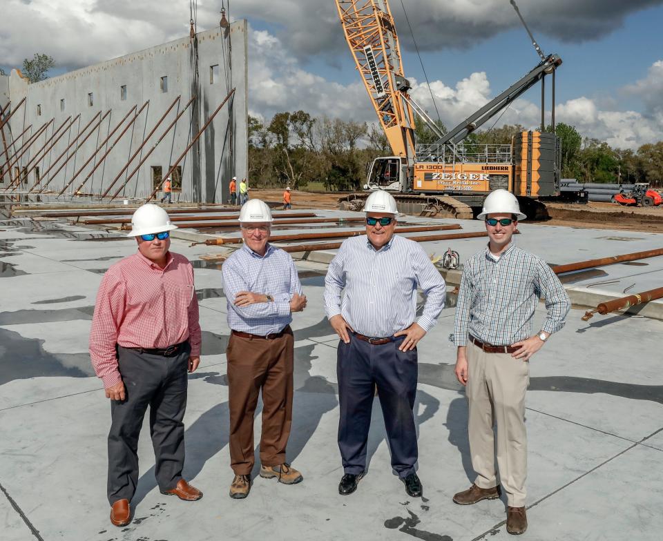 From left, Matt Ruthven, Joe L. Ruthven, Greg Ruthven and Brandon Clark at the construction site of three new warehouses totaling about 500,000 square feet in North Lakeland in 2019.