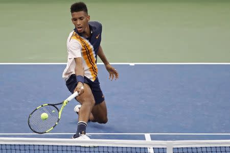 FILE PHOTO: Aug 27, 2018; New York, NY, USA; Felix Auger-Aliassime of Canada reaches for a forehand against Denis Shapovalov of Canada (not pictured) in the first round on day one of the 2018 U.S. Open tennis tournament at USTA Billie Jean King National Tennis Center. Mandatory Credit: Geoff Burke-USA TODAY Sports