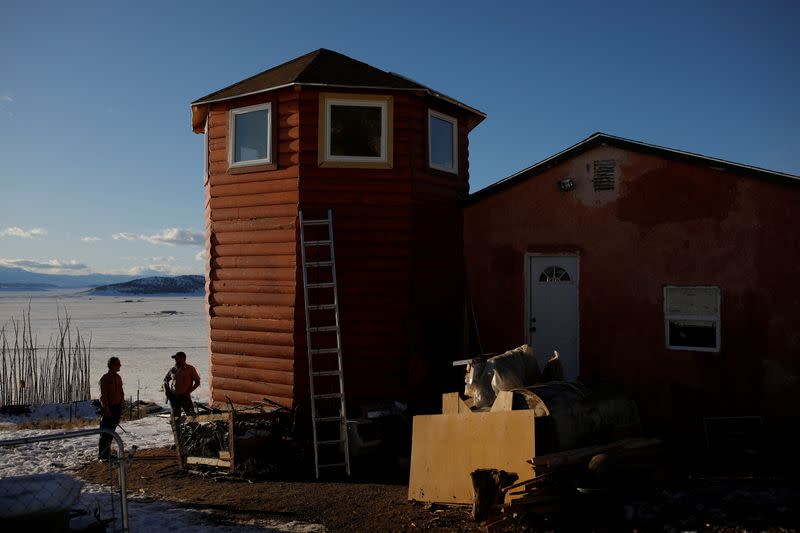 Drew Miller and Kacey Dawson stand outside a survival camp