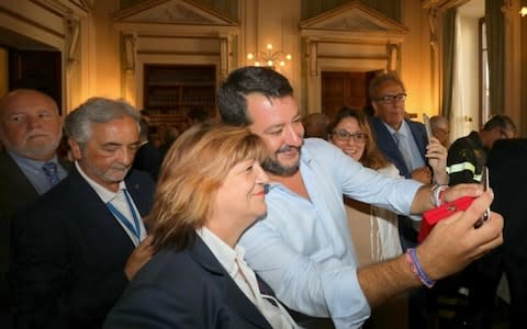 Mr Salvini posing for selfies with staff at a farewell encounter at the Italian interior ministry - Credit: REX