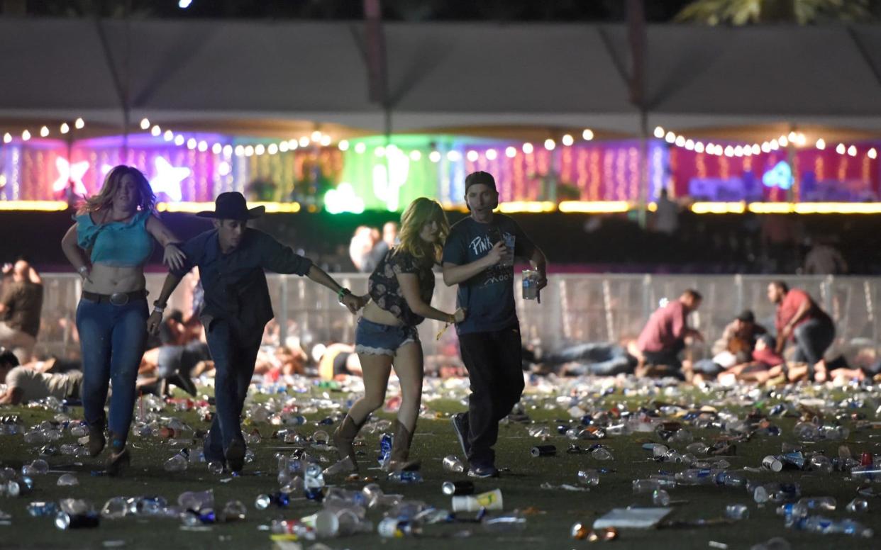 People run from the Route 91 Harvest country music festival - Getty Images North America