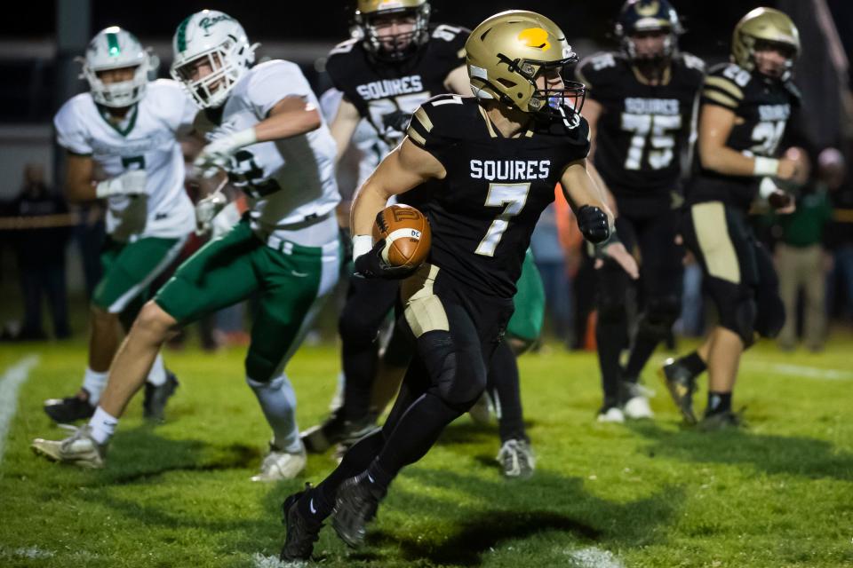 Delone Catholic's Gage Zimmerman (7) carries the ball for the Squires during a PIAA District 3 Class 2A semifinal game against Trinity at Delone Catholic High School on Friday, November 4, 2022, in McSherrystown.