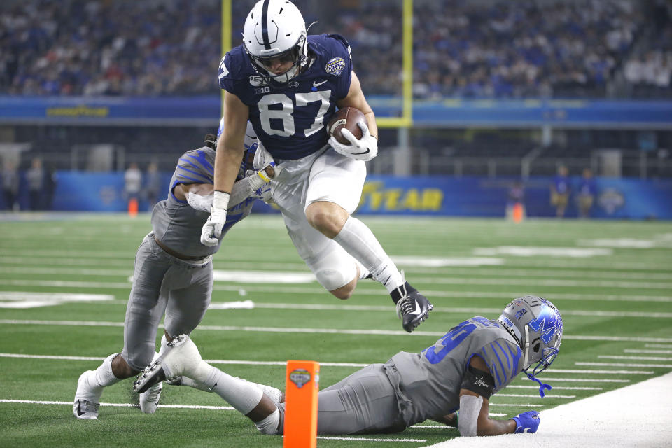 Penn State tight end Pat Freiermuth (87) leaps past Memphis defensive backs Chris Claybrooks (7) and Memphis Carlito Gonzalez (29) in the first half of the NCAA Cotton Bowl college football game, Saturday, Dec. 28, 2019, in Arlington, Texas. Freiermuth was ruled out of bounds inside the five yard line. (AP Photo/Ron Jenkins)