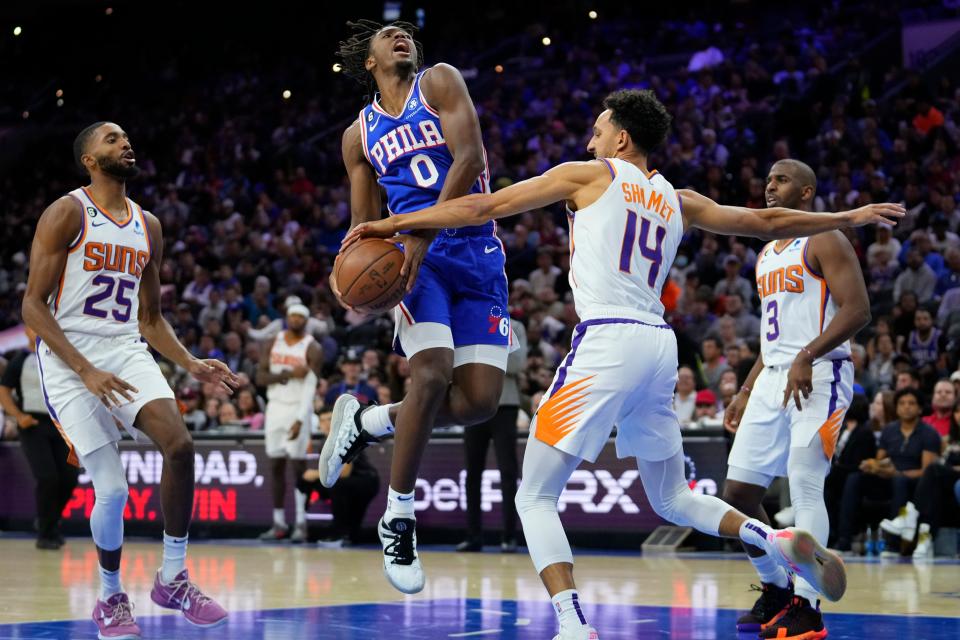 Philadelphia 76ers' Tyrese Maxey (0) tries to go up for a shot against Phoenix Suns' Landry Shamet (14) during the first half of an NBA basketball game, Monday, Nov. 7, 2022, in Philadelphia. (AP Photo/Matt Slocum)