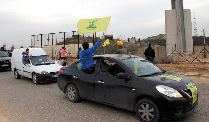 Hezbollah supporters rally near Fatima's Gate in Kfar Kila on the Lebanese border with Israel on February 10, 2018 to celebrate the crashing of an Israeli F16 fighter jet by Syrian air defences (AFP Photo/Ali DIA)