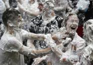 Students from St Andrews University are covered in foam as they take part in the traditional 'Raisin Weekend' in the Lower College Lawn, at St Andrews in Scotland, Britain October 17, 2016. REUTERS/Russell Cheyne