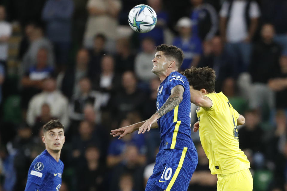 Chelsea's Christian Pulisic, left, jumps for a header with Villarreal's Pau Torres during the UEFA Super Cup soccer match between Chelsea and Villarreal at Windsor Park in Belfast, Northern Ireland, Wednesday, Aug. 11, 2021. (AP Photo/Peter Morrison)