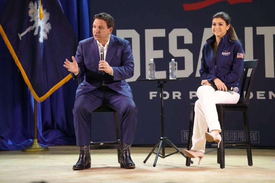 Florida Gov. Ron DeSantis, left, speaks during an event for his GOP presidential campaign as his wife Casey DeSantis looks on, on Friday, Dec. 1, 2023, in Prosperity, S.C. DeSantis is making a daylong swing through South Carolina, which holds the first southern Republican presidential primary of the 2024 campaign. (AP Photo/Meg Kinnard) ORG XMIT: SCMK102