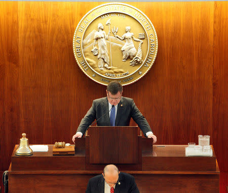 Speaker of the North Carolina House of Representatives Tim Moore (center) lowers his head in prayer as the chamber convenes to consider repealing the controversial HB2 law limiting bathroom access for transgender people in Raleigh, North Carolina, U.S. on December 21, 2016. REUTERS/Jonathan Drake