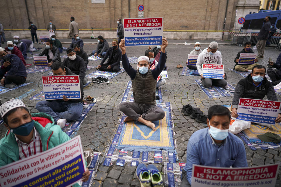 Members of an Italian Muslim association stage a sit-in and prayer to condemn what they see as persecutory acts against the Islamic community in France and against the publication of pictures and what they see as disrespect of the Prophet Muhammad, in Rome, Friday, Oct. 30, 2020. The protesters also condemned the attack in Nice, France. (AP Photo/Andrew Medichini)