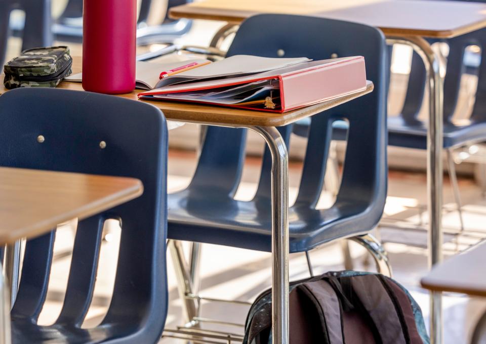 high school student desk with binder and notebook on top