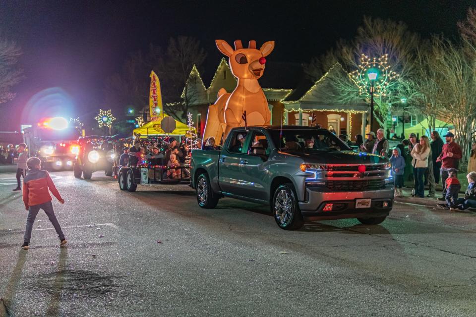Brightly-lit vehicles make their way through the streets of downtown Sylvania, Ga., during the annual Screven County Chamber of Commerce's "Christmas Extravaganza."